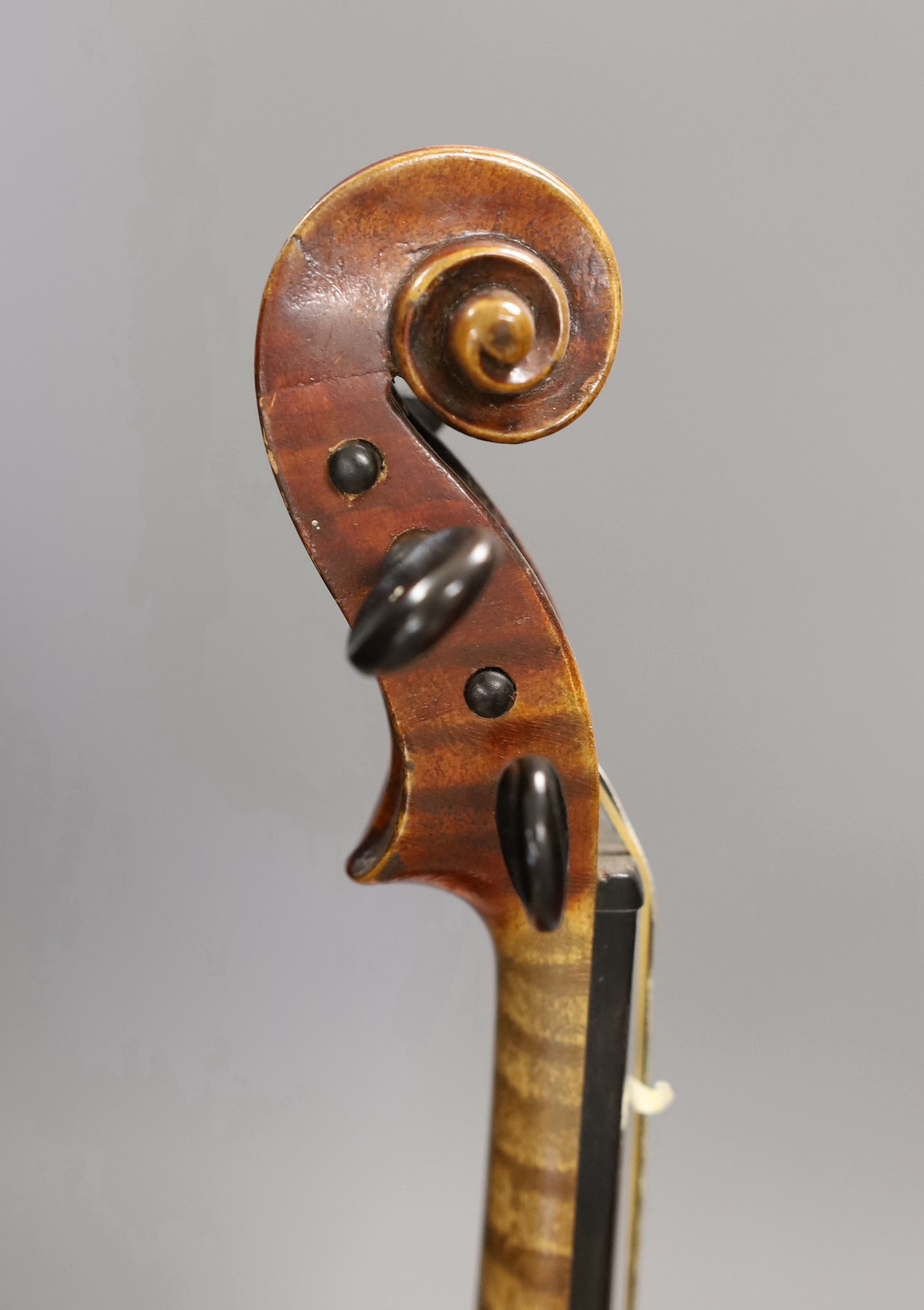 A quarter size late 19th century violin with bow, in E. Hill & Sons case, back measures 29cm
